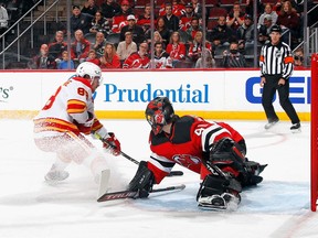 Flames forward Andrew Mangiapane scores his second goal of the game at 12:56 of the first period against Devils goalie Scott Wedgewood at the Prudential Center on Tuesday night in Newark, N.J.