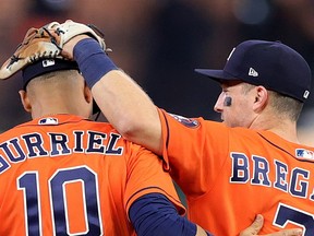 Houston Astros Yuli Gurriel and Alex Bregman celebrate the team's 7-2 win over the Atlanta Braves in Game 2 of the World Series at Minute Maid Park on Wednesday in Houston.