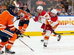 The Calgary Flames’ Johnny Gaudreau fires a shot on Edmonton Oilers goaltender Mikko Koskinen at Rogers Place in Edmonton on Monday, Oct. 4, 2021.