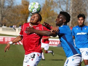 Cavalry FC’s Richard Luca gets control of the ball in front of FC Edmonton defender Tboy Fayia at ATCO Field at Spruce Meadows on Saturday, Oct. 9, 2021.