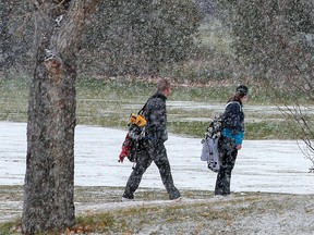 Confederation Park Golf Course golfers deal with a brief snow storm that hit the north part of the city on Monday, October 11, 2021.