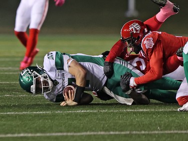 Saskatchewan Roughriders quarterback Cody Fajardo is tackled by the Calgary Stampeders defensive line during CFL action at McMahon Stadium in Calgary on Saturday, October 23, 2021. Gavin Young/Postmedia