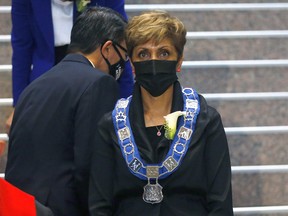 Councillor Sean Chu walks past Mayor Jyoti Gondek during the swearing-in ceremony at City Hall in Calgary on Monday, October 25, 2021.