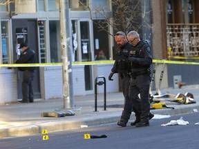 Calgary police investigate a fatal shooting on 8th Ave. between 6 St. and 5 St. S.W. in Calgary on Sunday, October 10, 2021.