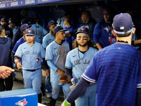 Bo Bichette of the Blue Jays and teammates leave the field after defeating the Baltimore Orioles at the Rogers Centre on Sunday, Oct. 3, 2021 in Toronto.