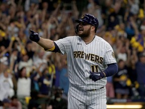 Rowdy Tellez of the Milwaukee Brewers reacts after hitting a home run in the seventh inning during Game 1 of his team's National League Division Series against the Atlanta Braves at American Family Field on Oct. 8, 2021 in Milwaukee.