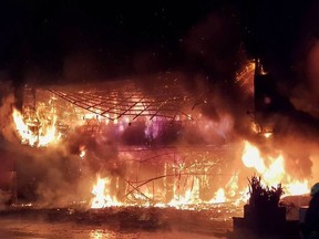 This handout photo released by the Kaohsiung Fire Department on October 14, 2021 shows firefighters battling an overnight blaze that tore through a building in the southern Taiwanese city of Kaohsiung, killing at least 46 people and injuring dozens of others.