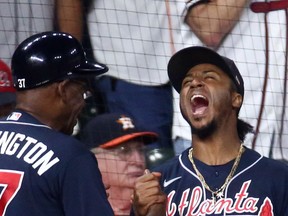 Atlanta Braves second baseman Ozzie Albies (right) celebrates with third-base coach Ron Washington after tagging out Houston Astros first-baseman Yuli Gurriel (not pictured) during the eighth inning in Game 1 of the 2021 World Series at Minute Maid Park.