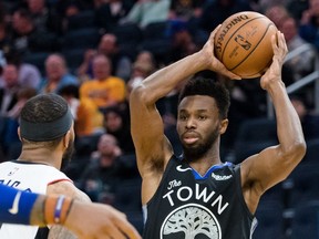 Golden State Warriors guard Andrew Wiggins passes the ball against LA Clippers forward Marcus Morris Sr. in the second half at Chase Center.