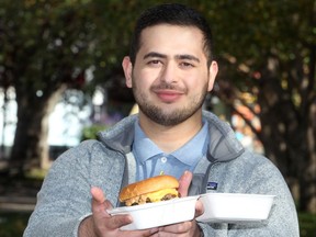 Farbod Jahanshah is seen with a burger from Alumni Sandwiches along 17th Ave. SW. Jahanshah has created a rating system to rank Calgary's best burger restaurant. Tuesday, September 28, 2021. Brendan Miller/Postmedia