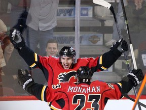 Calgary Flames Mikael Backlund celebrates his goal on the Minnesota Wild with teammate Sean Monahan. THe Pair are among 4 temporary co-captains for the Flames.