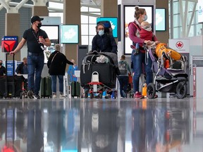Travellers move through the Calgary International Airport on Wednesday, October 6, 2021. Effective October 30, travellers departing from Canadian airports, and travellers on VIA Rail and Rocky Mountaineer trains, will be required to be fully vaccinated in order to travel.
