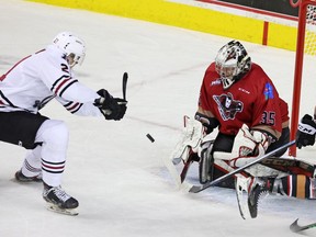 Calgary Hitmen goalie Brayden Peters stops a shot from the Red Deer Rebels’ Dallon Melin at the Scotiabank Saddledome in Calgary on Friday, Oct. 15, 2021.