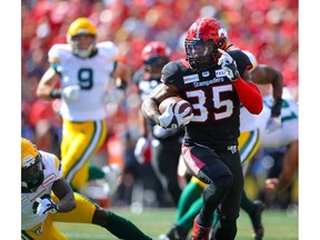 The Calgary Stampeders’ Ka’Deem Carey runs for a touchdown against the Edmonton Elks at McMahon Stadium in Calgary on Monday, Sept. 6, 2021.