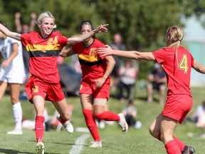 The Calgary Dinos celebrate a goal from Rachel Barlow against the host Mount Royal Cougars on Saturday, Sept. 4. The Dinos won 3-0.