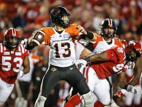 BC Lions quarterback Michael Reilly throws the ball as Calgary Stampeders close in at McMahon Stadium in Calgary on Thursday, Aug. 12, 2021.