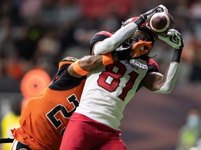 The Calgary Stampeders’ Luther Hakunavanhu makes a touchdown reception as the BC Lions’ Jalon Edwards-Cooper defends at BC Place in Vancouver on Saturday, Oct. 16, 2021.
