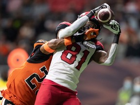 The Calgary Stampeders’ Luther Hakunavanhu makes a touchdown reception as the B.C. Lions’ Jalon Edwards-Cooper defends at BC Place in Vancouver on Saturday, Oct. 16, 2021.