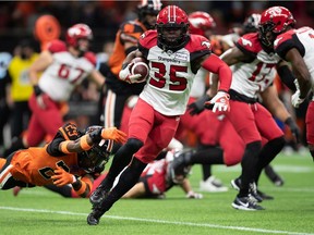 The Calgary Stampeders’ Ka’Deem Carey gets away from BC Lions’ Jalon Edwards-Cooper at BC Place in Vancouver on Saturday, Oct. 16, 2021.