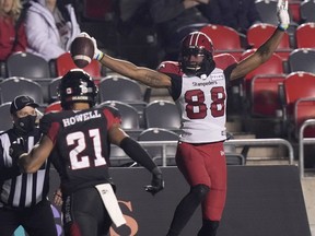 Calgary Stampeders wide receiver Kamar Jorden scores a touchdown as Ottawa Redblacks defensive back Justin Howell looks on at TD Place Stadium in Ottawa on Friday, Oct. 29, 2021.