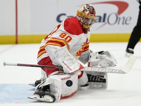 Calgary Flames goaltender Daniel Vladar stops the puck against the Washington Capitals at Capital One Arena in Washington on Saturday, Oct. 23, 2021.