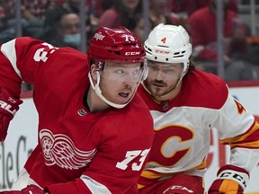 Red Wings left wing Adam Erne looks to pass with Calgary Flames defenceman Rasmus Andersson in hot pursuit during last Thursday's date in Detroit.