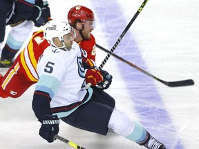 The Calgary Flames’ Blake Coleman battles the Seattle Kraken’s Mark Giordano in NHL preseason action at the Saddledome in Calgary on Wednesday, Sept. 29, 2021.