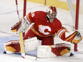 Calgary Flames goaltender Dustin Wolf makes a save against the Vancouver Canucks during a preseason game at the Saddledome on Friday, Oct. 1, 2021.