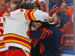 Calgary Flames defencemen Rasmus Andersson fights Edmonton Oilers forward Kailer Yamamoto at Rogers Place in Edmonton on Saturday, Oct. 16, 2021.
