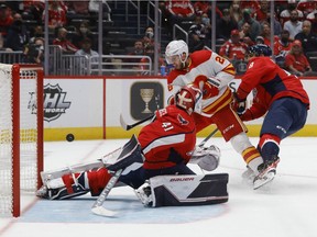 The Calgary Flames’ Elias Lindholm scores a goal on Washington Capitals goaltender Vitek Vanecek at Capital One Arena in Washington on Saturday, Oct. 23, 2021.