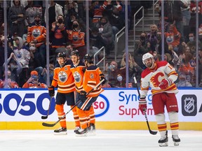 Edmonton Oilers' Jesse Puljujarvi (13) celebrates a goal with teammates on Calgary Flames' goaltender Jacob Markstrom (25) during second period preseason NHL action at Rogers Place in Edmonton, on Monday, Oct. 4, 2021. Photo by Ian Kucerak