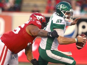 Stamps Andrew Seinet-Spaulding (L) tackles Roughriders Cody Fajardo during CFL football action between the Saskatchewan Roughriders and the Calgary Stampeders at McMahon Stadium in Calgary on Saturday, October 2, 2021. Jim Wells/Postmedia