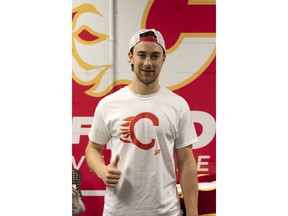 Andrew Mangiapane models a T-shirt that features his hand-drawn attempt at the Calgary Flames’ logo. The shirts are now for sale through the team store, with all proceeds to Mangiapane’s charity of choice — the Hotchkiss Brain Institute.
