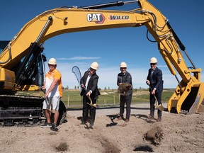 Willie Miller of Bordeaux Properties, left, Claudio Palumbo of Qualico Communities, Barry Ehlert of Windmill Golf Group, and Peter Maat of Wilco celebrate the start of the clubhouse for Mickelson National Golf Club.