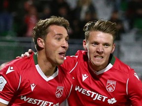 Cavalry FC sniper Daan Klomp (at left) celebrates his first-half goal with teammate Joe Mason during Thursday night's CPL matchup against Pacific FC at ATCO Field at Spruce Meadows in Calgary.