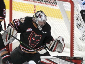 Hitmen netminder Brayden Peters makes a pad save during first-period action against the high-powered Winnipeg Ice last night at the Saddledome.