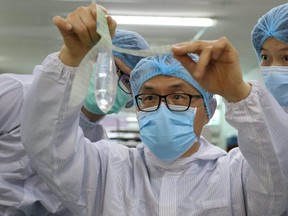 Founder and inventor of Wondaleaf Unisex Condom John Tang Ing Ching inspects the unisex condom at his factory in Sibu, Malaysia, Oct. 19, 2021.