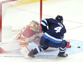 Winnipeg Jets defenceman Neal Pionk is unable to convert a chance in close on Calgary Flames goaltender Daniel Vladar during preseason NHL action at Canada Life Centre in Winnipeg on Wednesday, Oct. 6, 2021.