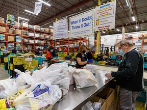 Volunteers sort donated foods at Calgary Food Bank’s warehouse on Wednesday, November 17, 2021.