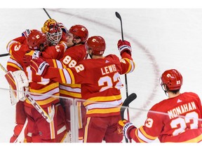 The Calgary Flames celebrate a seven-round shootout win against Pittsburgh Penguins at the Scotiabank Saddledome in Calgary on Monday, Nov. 29, 2021.