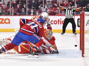 Brendan Gallagher #11 of the Montreal Canadiens tips the puck past goaltender Jacob Markstrom #25 of the Calgary Flames during the second period at Centre Bell on November 11, 2021 in Montreal, Canada.