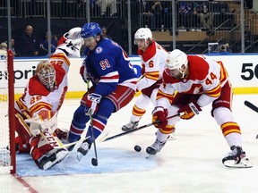 Calgary Flames goaltender Jacob Markstrom makes a save on the New York Rangers’ Sammy Blais at Madison Square Garden in New York on Oct. 25, 2021.
