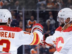 Flames Oliver Kylington and Johnny Gaudreau celebrate Kylington's first-period marker against the Philadelphia Flyers on Tuesday night at Wells Fargo Center.