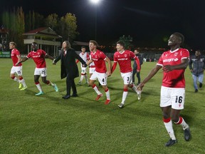 Cavalry FC players and general manager/head coach Tommy Wheeldon Jr. celebrate a 2-1 victory against York United FC at ATCO Field at Spruce Meadows on Oct. 14, 2021.