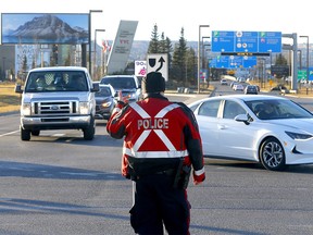 Calgary police block vehicle traffic back into the airport at Barlow Trail as anti-vax protestors planned to rally at the Calgary International Airport in Calgary on Sunday, November 7, 2021.