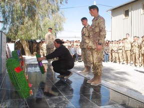 Josee Simard, whose daughter Cpl. Karine Blais was killed in Afghanistan on April 13, 2009, lays a wreath during a Remembrance Day ceremony at Kandahar Airfield, Afghanistan, Thursday Nov. 11, 2010.