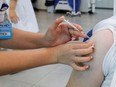 An Israeli man receives his third dose of the COVID-19 vaccine, in Beit Shemesh, Israel, Oct. 14, 2021.