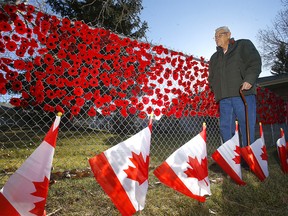 Resident, Stan Phillips looks over some of the 1,500 knitted and crocheted poppies residents of Silvera’s Shouldice community displayed to pay tribute to veterans this Remembrance Day. The display also includes 158 specially designed poppies to commemorate the Canadian soldiers and six service dogs killed in the line of duty in Afghanistan, as well as 54 flags created by Shouldice residents to represent their own personal stories located at 4730 19 Avenue NW in Calgary on Monday, November 8, 2021.