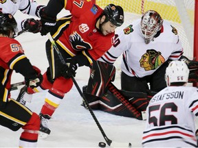 The Calgary Flames’ Milan Lucic works the puck in front of the Chicago Blackhawks net at the Saddledome in Calgary on Feb. 15, 2020.