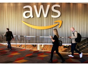 Amazon Web Services said Monday it is creating a major infrastructure region in the Calgary area and initial work on the project has already begun. Pictured, attendees at Amazon.com Inc annual cloud computing conference walk past the Amazon Web Services logo in Las Vegas. REUTERS/Salvador Rodriguez/File Photo.